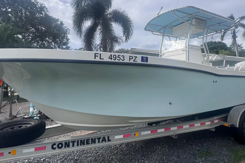 The Image of Dusky 278 boat on trailer, Florida registration, palm trees in background. - 0