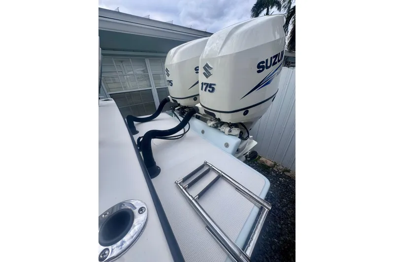 Slide: The Image of Twin Suzuki 175 outboard engines on a 2015 Dusky 278 boat, featuring lean burn technology. - 13