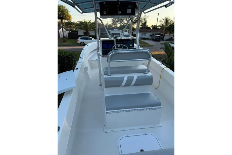 Slide: The Image of 2015 Dusky 278 boat interior with bench seat and twin 175 engines. - 15