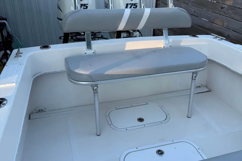 Slide: The Image of Dusky 278 boat interior, 2015 model, featuring spacious storage compartments and clean white finish. - 16