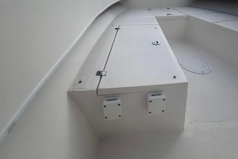 Slide: The Image of 2015 Dusky 278 boat deck with storage compartment, featuring clean white surfaces. - 18