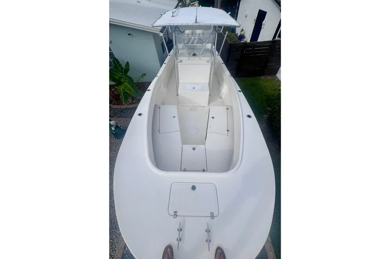 Slide: The Image of 2015 Dusky 278 boat interior with blue canopy and seating area. - 22