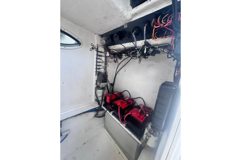 Slide: The Image of Interior view of a 2015 Dusky 278 boat compartment with wiring and equipment. - 30
