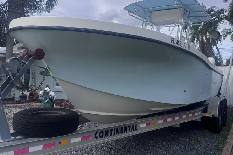 Slide: The Image of Dusky 278 boat on trailer, 2015 model, parked outdoors with palm trees. - 4
