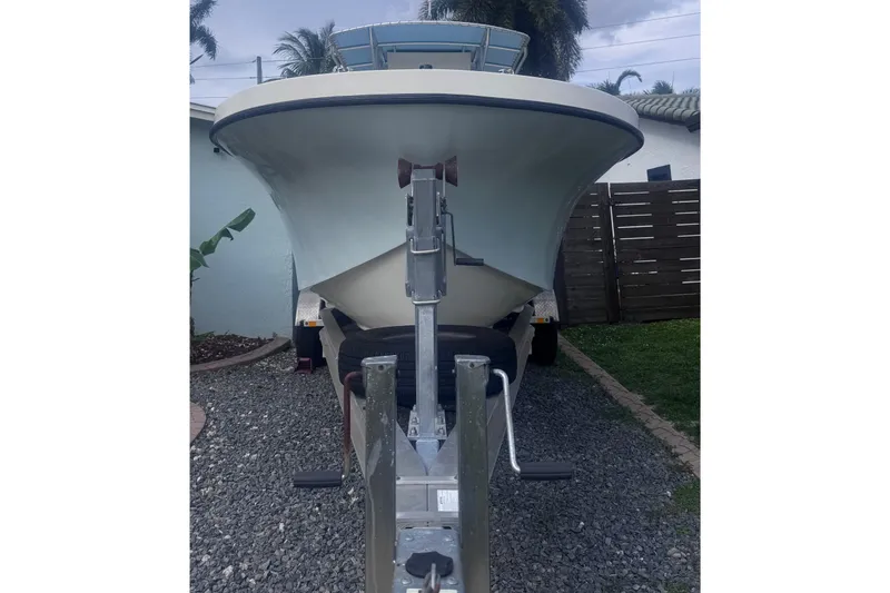 Slide: The Image of Dusky 278 boat on trailer, 2015 model, parked on gravel driveway. - 5