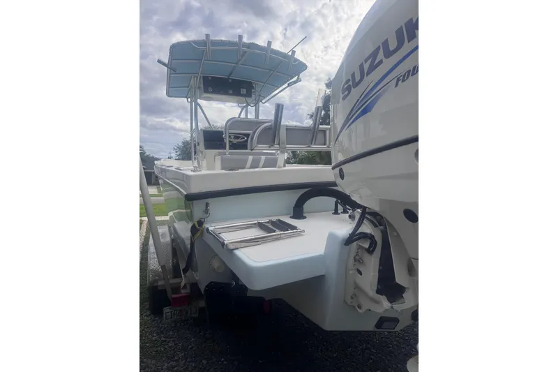 Slide: The Image of Twin Suzuki 175 outboard engines on a 2015 Dusky 278 boat, featuring precision control. - 8