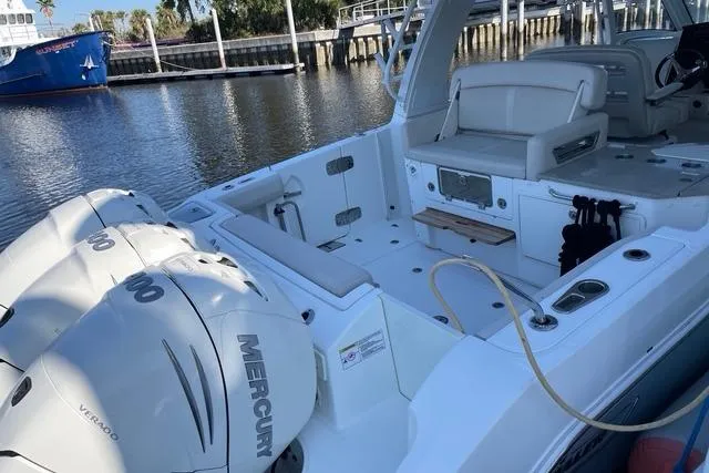 Slide: The Image of 2020 Boston Whaler 350 Realm boat with Mercury engines docked by the water. - 10