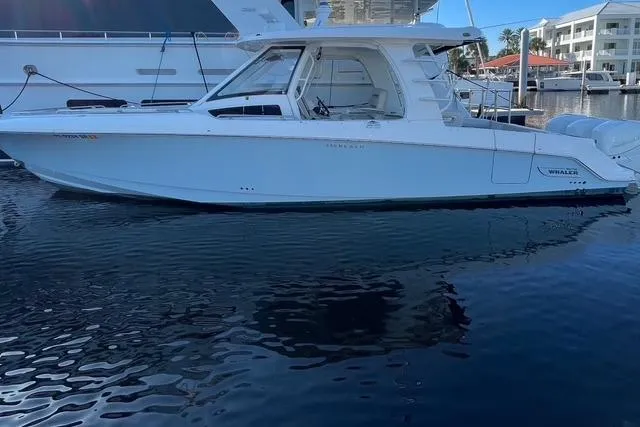 Slide: The Image of 2020 Boston Whaler 350 Realm boat docked in marina, side view. - 6