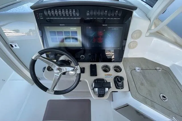 Slide: The Image of Cockpit of 2020 Boston Whaler 350 Realm with advanced navigation controls and dual screens. - 9