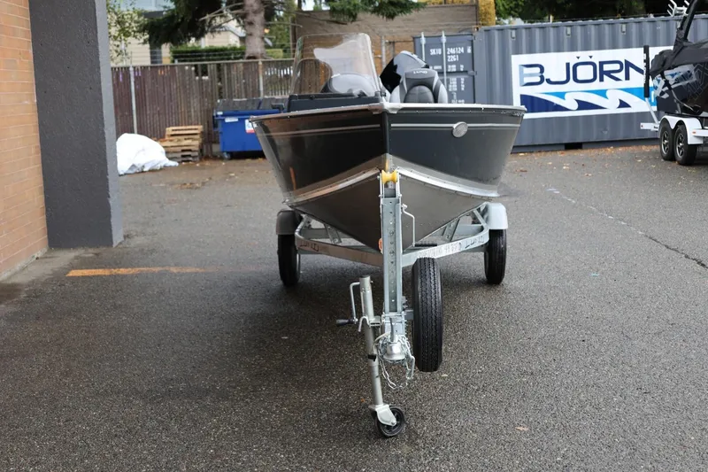 Slide: The Image of 2026 Lund 1600 Fury SS boat on trailer in outdoor setting. - 11