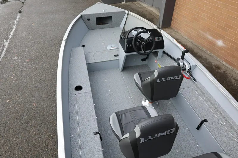 Slide: The Image of 2026 Lund 1600 Fury SS boat interior with steering console and seating. - 16