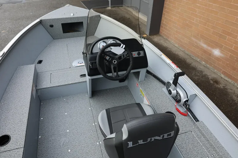 Slide: The Image of 2026 Lund 1600 Fury SS boat interior with steering wheel and seating. - 17