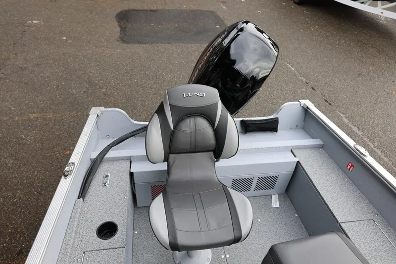 Slide: The Image of 2026 Lund 1600 Fury SS boat interior with cushioned seat and motor. - 20