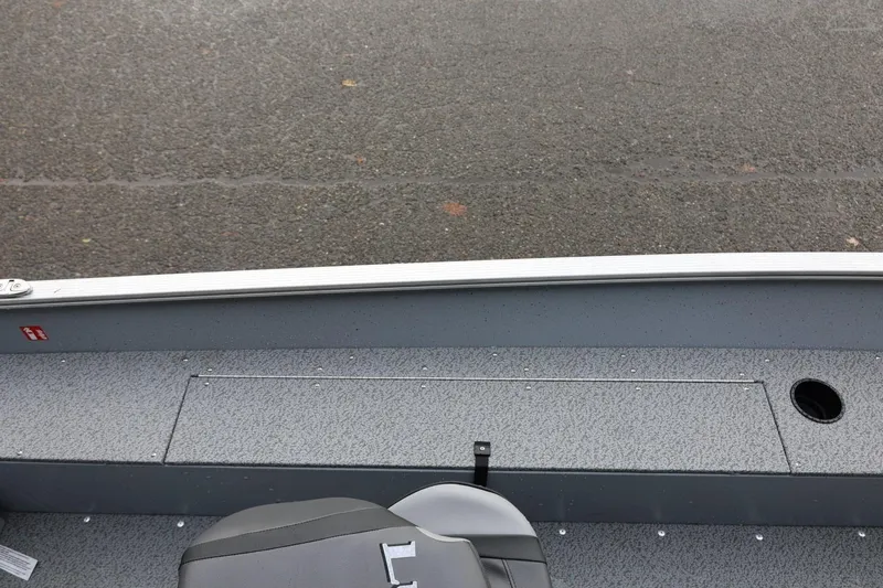 Slide: The Image of 2026 Lund 1600 Fury SS boat interior with gray flooring and seating. - 21