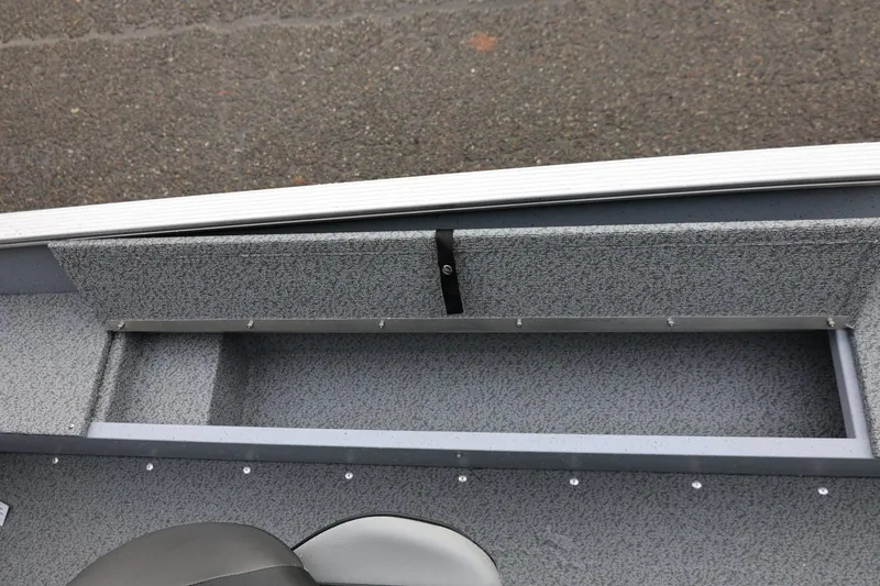 Slide: The Image of 2026 Lund 1600 Fury SS boat interior with storage compartment and seating. - 22