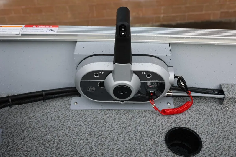 Slide: The Image of Throttle control panel on a 2026 Lund 1600 Fury SS boat, featuring safety lanyard. - 25