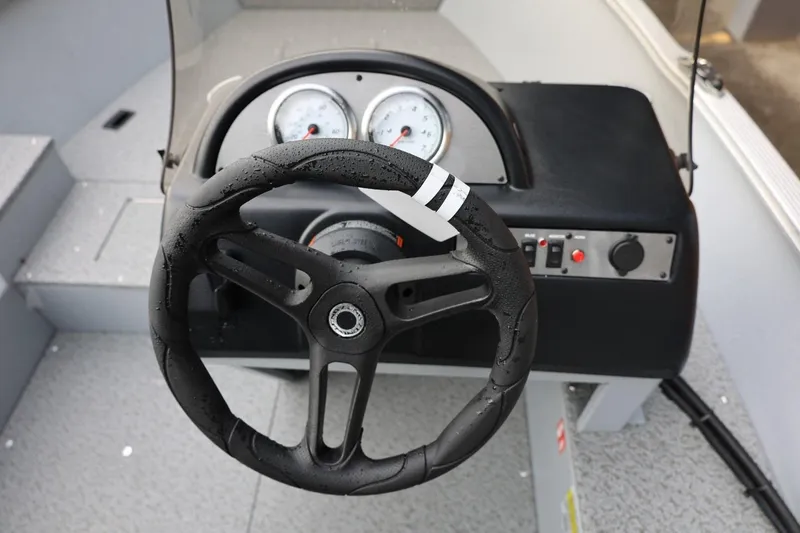 Slide: The Image of Steering console of 2026 Lund 1600 Fury SS boat with gauges and controls. - 26