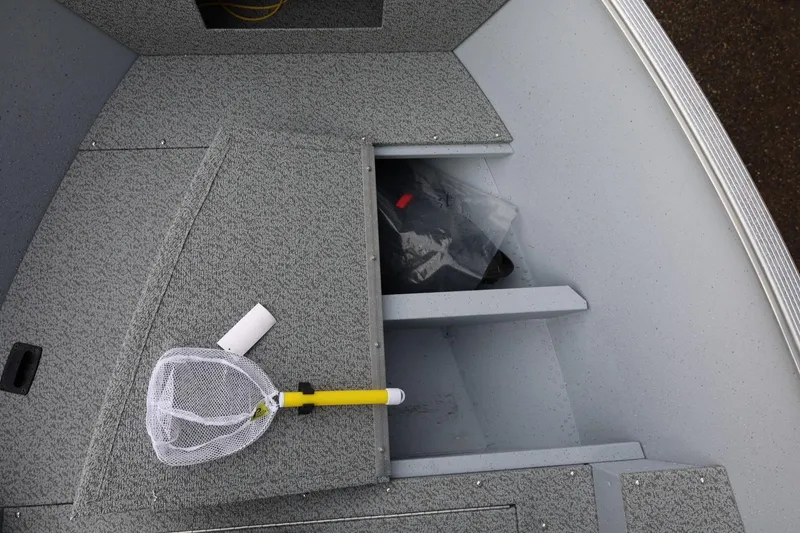 Slide: The Image of Interior of 2026 Lund 1600 Fury SS boat with storage and fishing net. - 30