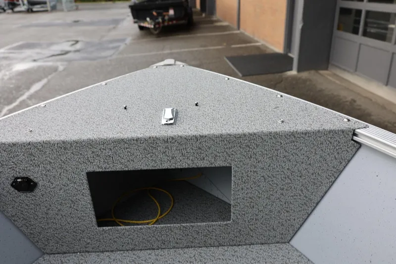 Slide: The Image of 2026 Lund 1600 Fury SS boat interior with gray textured surface and storage compartment. - 31