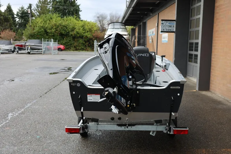 Slide: The Image of 2026 Lund 1600 Fury SS boat with outboard motor in a parking lot. - 5