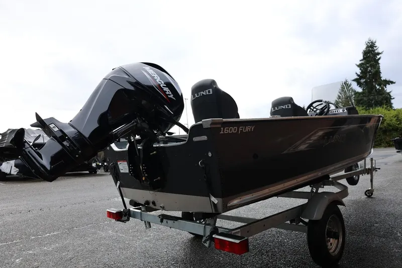 Slide: The Image of 2026 Lund 1600 Fury SS boat with Mercury outboard motor on trailer. - 8