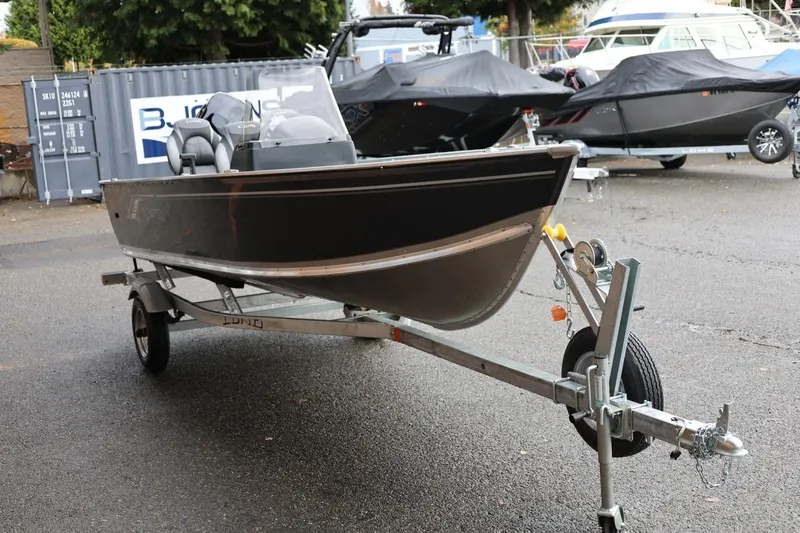 Slide: The Image of 2026 Lund 1600 Fury SS boat on trailer in outdoor setting. - 9