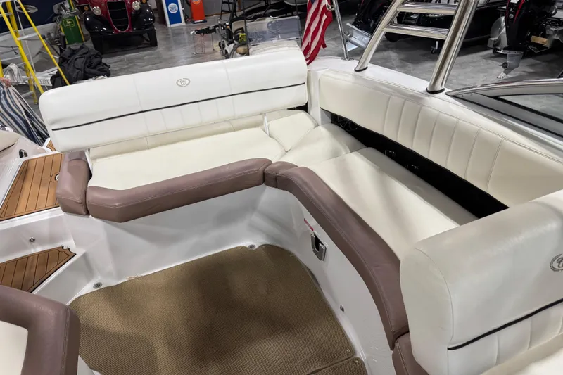 Slide: The Image of Interior seating of a 2012 Cobalt 276 boat with white and brown upholstery. - 10
