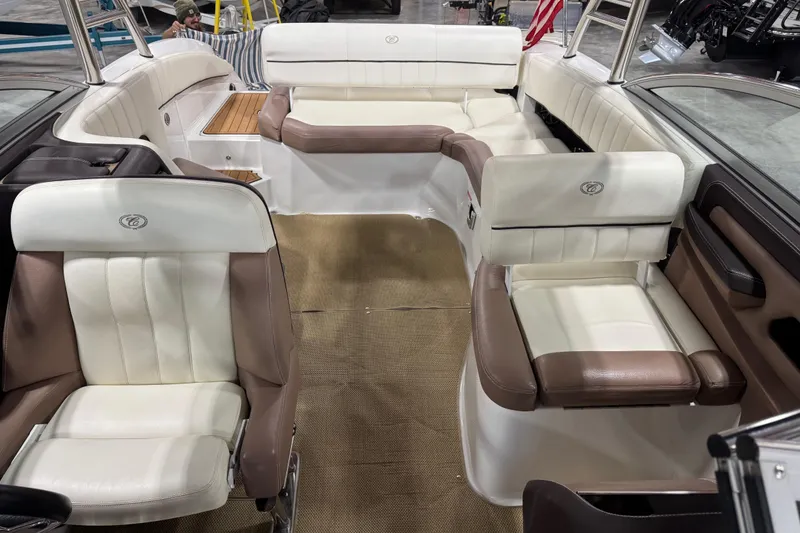Slide: The Image of Interior of a 2012 Cobalt 276 boat with white and brown seating. - 11