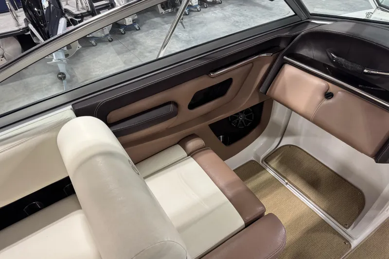 Slide: The Image of Interior of a 2012 Cobalt 276 boat with beige and brown seating. - 13
