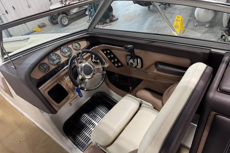 Slide: The Image of Interior of a 2012 Cobalt 276 boat, featuring steering wheel and dashboard controls. - 14