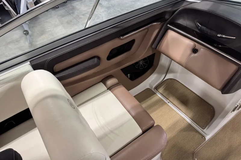 Slide: The Image of Interior of a 2012 Cobalt 276 boat, featuring beige and brown seating. - 15