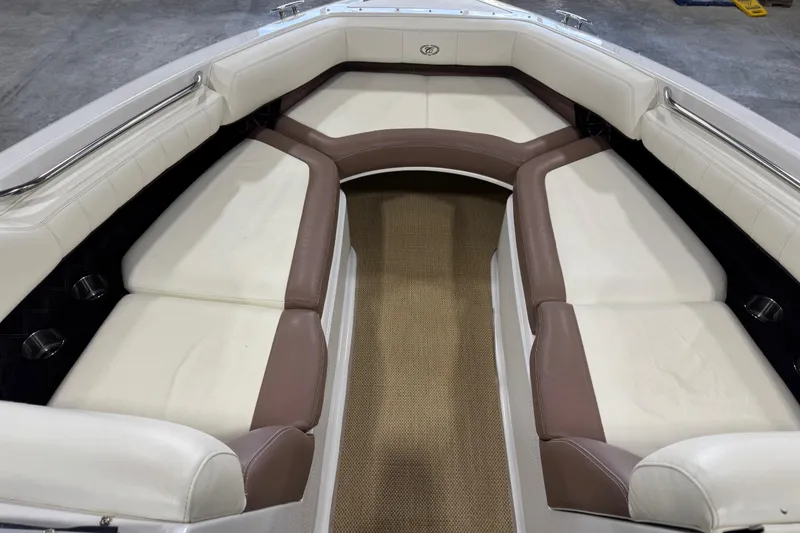 Slide: The Image of 2012 Cobalt 276 boat interior with white and brown cushioned seating. - 17