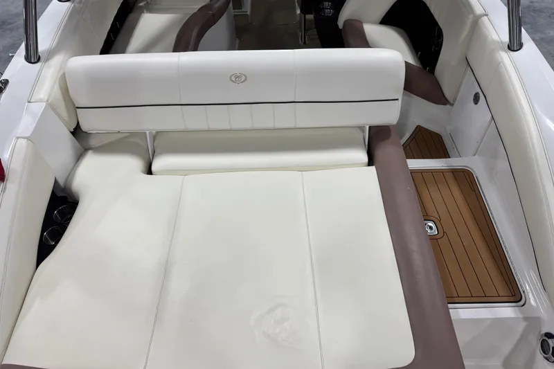 Slide: The Image of 2012 Cobalt 276 boat interior with white and brown seating, featuring teak-style flooring. - 6