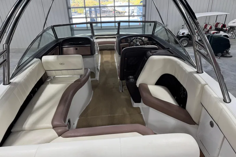 Slide: The Image of 2012 Cobalt 276 boat interior with white and brown seating, sleek design, and spacious layout. - 7