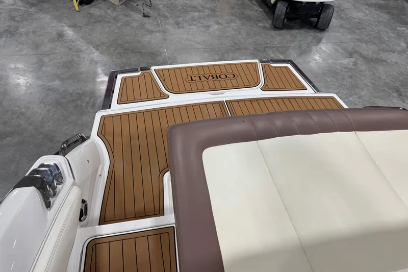 Slide: The Image of 2012 Cobalt 276 boat with teak-style deck and cushioned seating. - 8