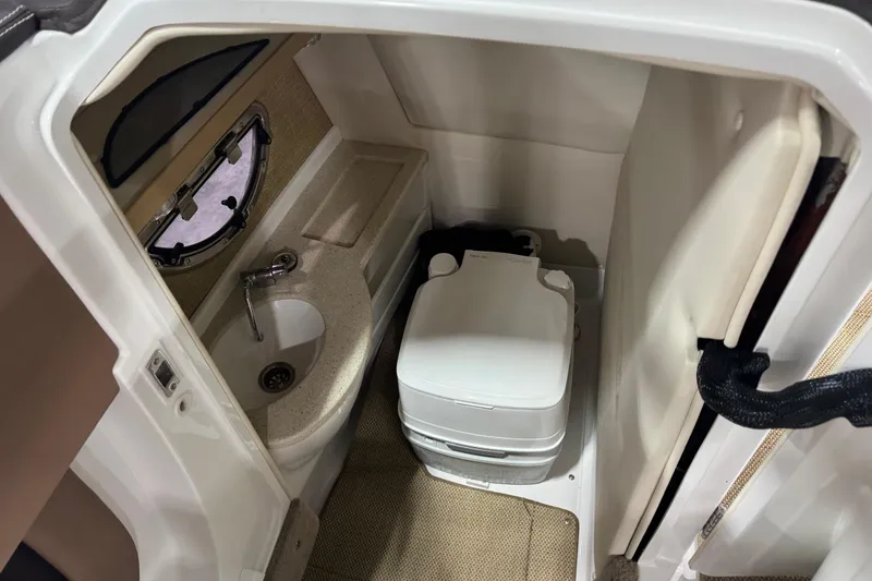 Slide: The Image of Compact bathroom in 2012 Cobalt 276 boat with sink and portable toilet. - 9