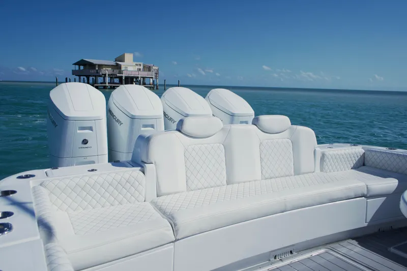 Slide: The Image of 2023 HCB 53 Sueños boat on open sea with city skyline in background. - 11