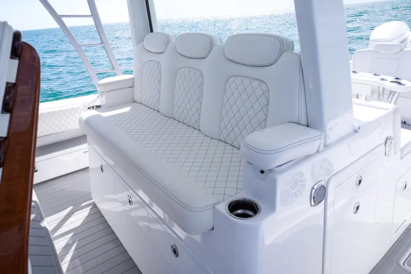 Slide: The Image of 2023 HCB 53 Sueños boat cruising on open ocean under a partly cloudy sky. - 28