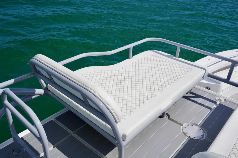 Slide: The Image of Luxury seating on 2023 HCB 53 Sueños boat, overlooking clear blue water. - 42