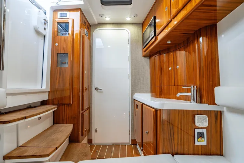 Slide: The Image of Luxurious interior of 2023 HCB 53 Sueños boat with wood finishes and modern amenities. - 43