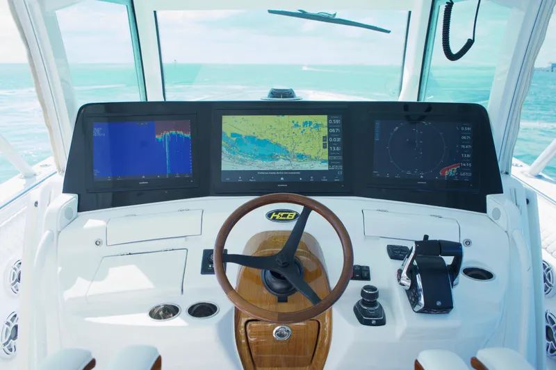 Slide: The Image of 2023 HCB 53 Sueños boat cruising on calm ocean waters under a partly cloudy sky. - 8