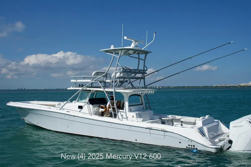 The Image of 2023 HCB 53 Sueños boat cruising on clear blue water under a partly cloudy sky. - 0