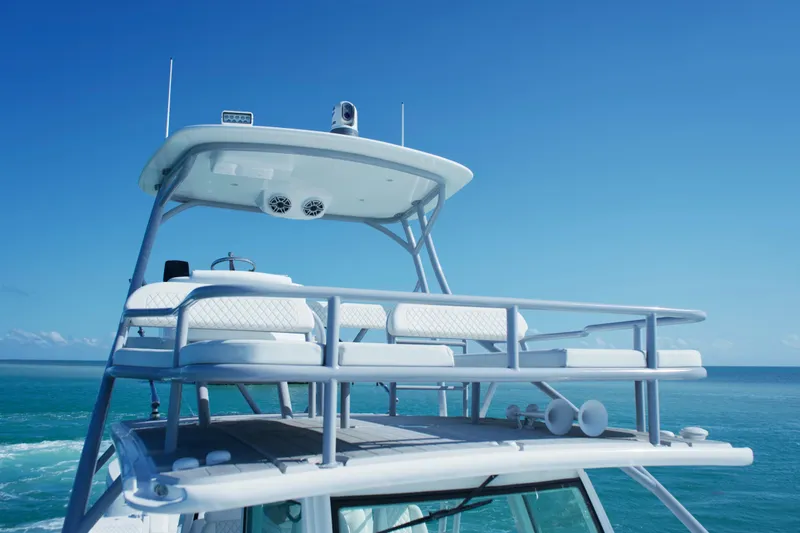 Slide: The Image of 2023 HCB 53 Sueños boat on open water under a partly cloudy sky. - 13