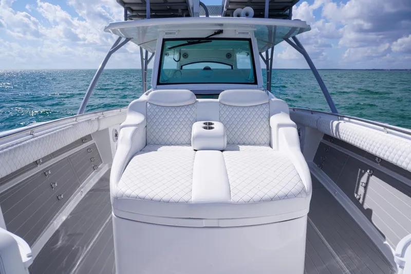 Slide: The Image of Luxurious 2023 HCB 53 Sueños boat interior with plush seating on open ocean. - 22