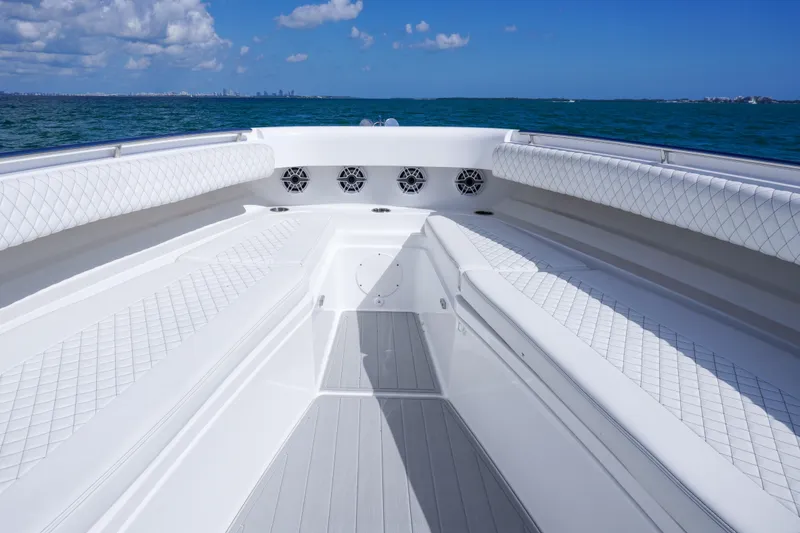 Slide: The Image of 2023 HCB 53 Sueños boat interior with white seating, ocean view, and blue sky. - 24