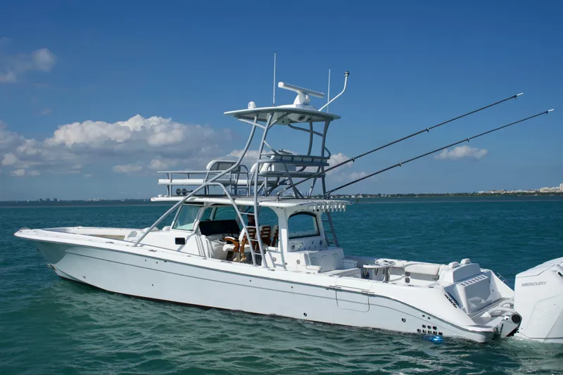 Slide: The Image of 2023 HCB 53 Sueños boat cruising on clear blue water under a sunny sky. - 3