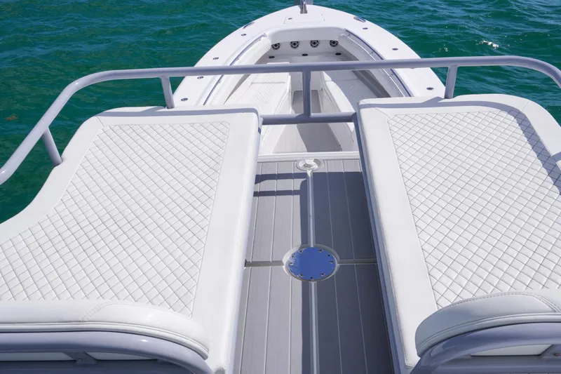 Slide: The Image of 2023 HCB 53 Sueños boat seating with white quilted upholstery and storage compartments. - 35