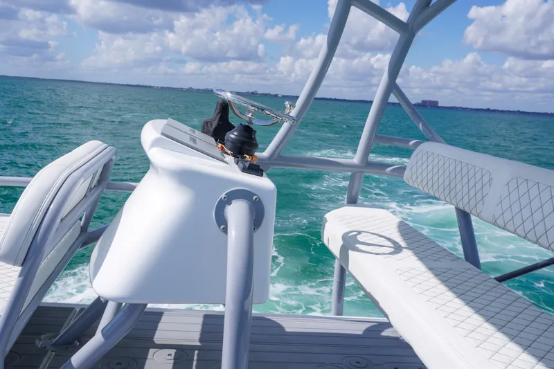 Slide: The Image of 2023 HCB 53 Sueños boat helm with ocean view, featuring sleek seating and modern design. - 41