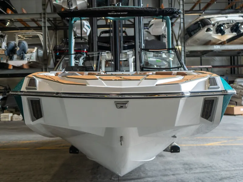 Slide: The Image of 2026 Malibu M230 boat in warehouse, front view. - 9
