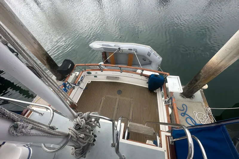 Slide: The Image of 1976 Grand Banks Sedan boat docked, aerial view showing deck and dinghy. - 11